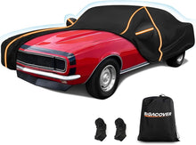 Load image into Gallery viewer, A premium black car cover with orange reflective trim partially covering a red classic muscle car, shown with a BiGACOVER storage bag and two additional fastening straps.
