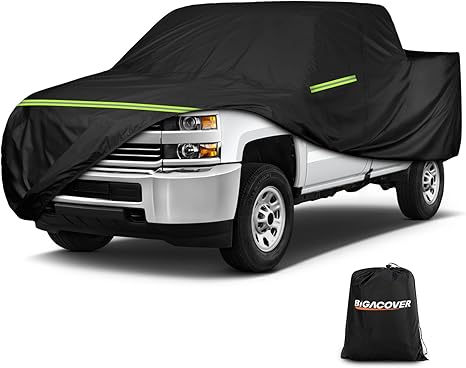 Black truck cover on a white truck with Big Cover logo.