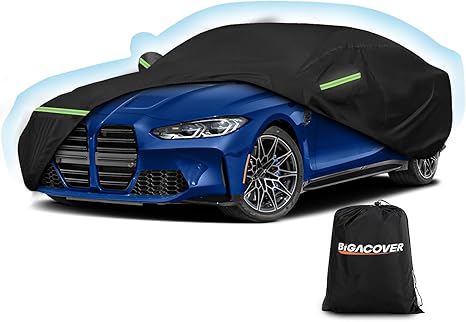 Blue car partially covered by a black car cover with a Bigacover bag on a white background