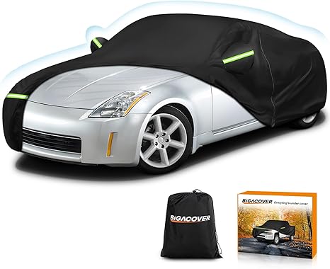 Car covered with a black car cover, next to a Bigacover bag and box on a white background