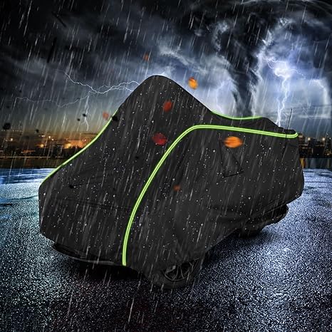 Motorcycle covered with a rain cover during a stormy night.
