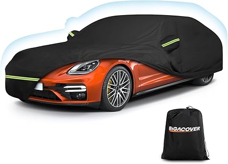 Orange car partially covered by a black car cover with 'BIGACOVER' branding.